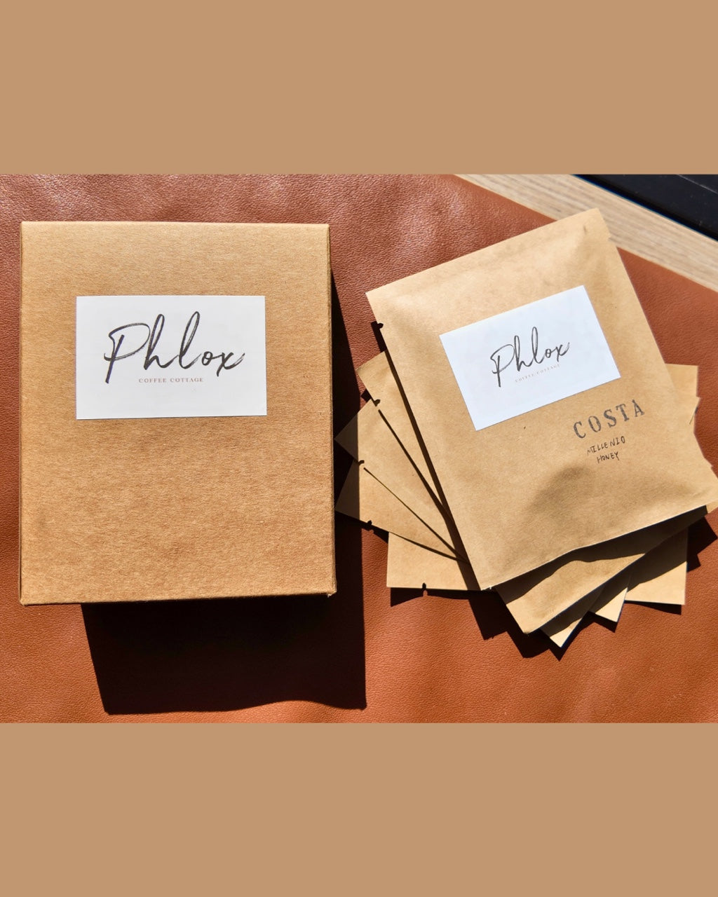 Kraft paper packaging with 'Phlox' branding on a brown surface